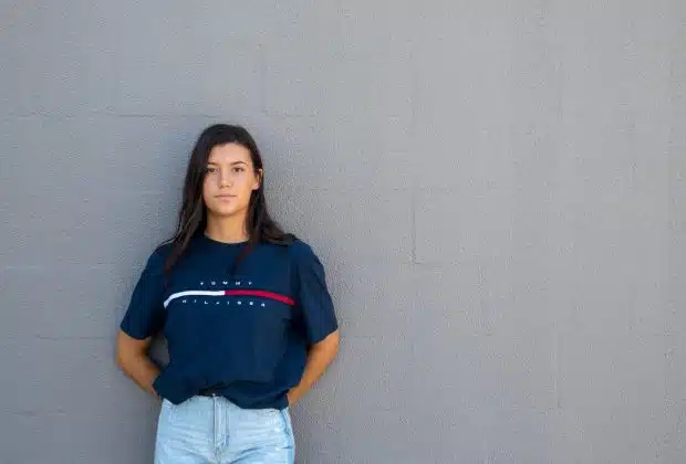 woman standing while leaning on wall